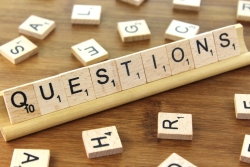 Scrabble tiles spelling out "questions"